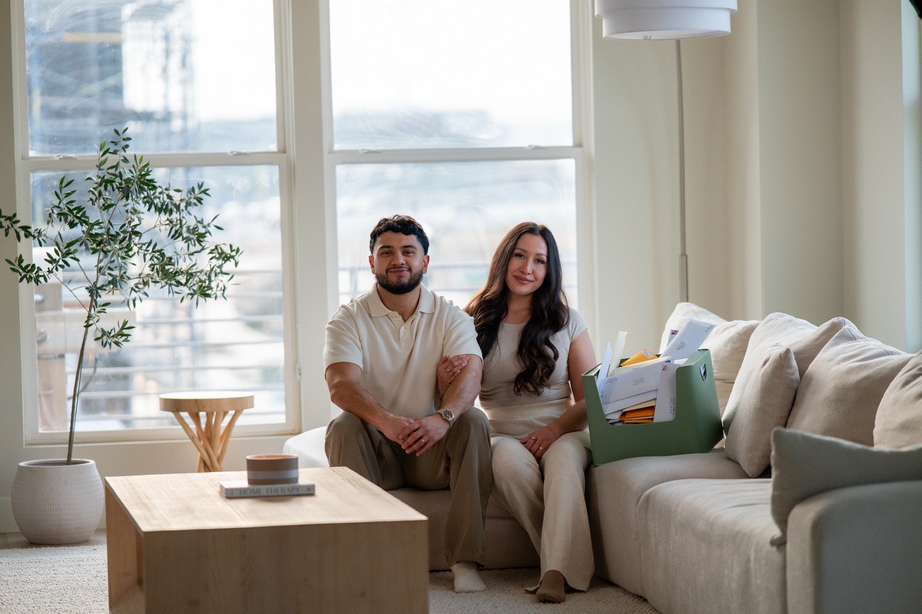 Javier and Stephany at home with a box of dispute letters